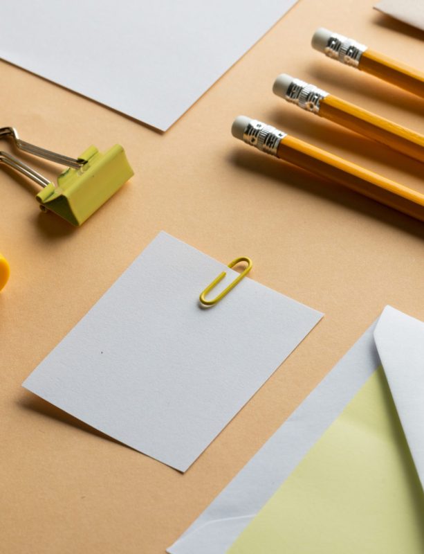 Flat lay of yellow pencils, sharpener and white paper with copy space on yellow background. School materials, writing, colouring, drawing, learning, school and education concept.