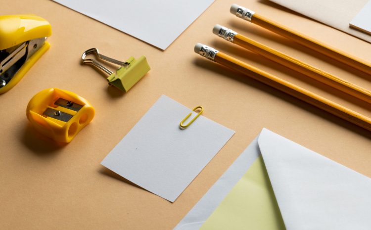 Flat lay of yellow pencils, sharpener and white paper with copy space on yellow background. School materials, writing, colouring, drawing, learning, school and education concept.